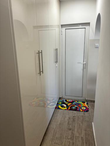 a room with a door and a colorful rug on the floor at АпартаменЪТ у Град in Belogradchik