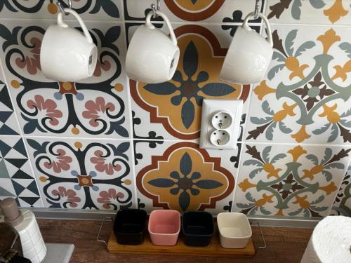 a bathroom with colorful tiles and lights on a wall at АпартаменЪТ у Град in Belogradchik