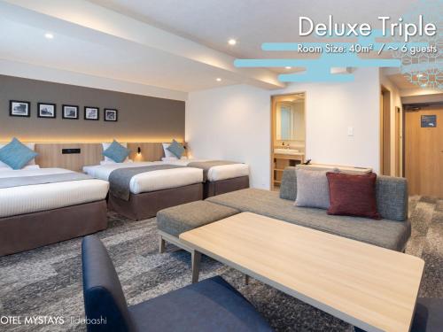 a hotel room with two beds and a couch at HOTEL MYSTAYS Iidabashi in Tokyo