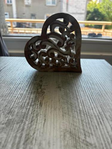 a heart shaped object sitting on top of a table at АпартаменЪТ у Град in Belogradchik
