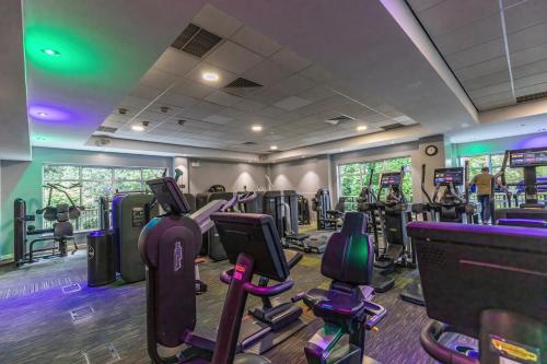 a gym with treadmills and elliptical machines at The Lodge At Meyrick Park in Bournemouth