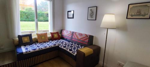 a couch in a room with a window at Appartement Deauville Plage Front de mer in Deauville