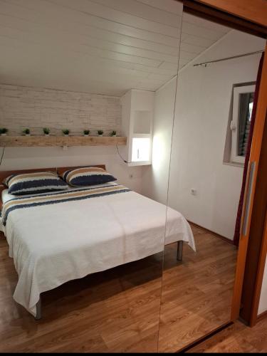a bedroom with a bed with a glass wall at Villa D`Amante in Klis