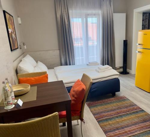 a hotel room with a bed and a table and chairs at Hotel Central in Bamberg