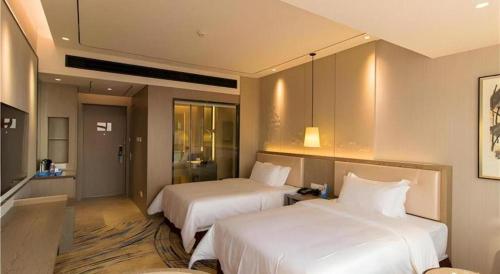 a hotel room with two beds in a room at Clear Lake Hotel in Shanwei