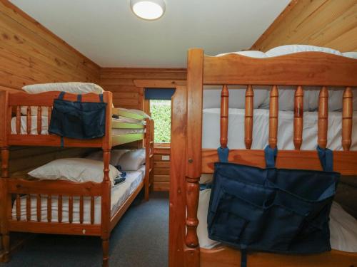 a bedroom with two bunk beds in a cabin at Shore Lodge Brodick Castle in Brodick