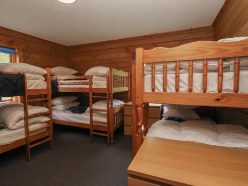 a room with four bunk beds in a cabin at Shore Lodge Brodick Castle in Brodick
