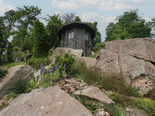 a small building sitting on top of some rocks at Shore Lodge Brodick Castle in Brodick