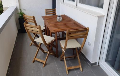 a wooden table and chairs sitting on a balcony at Apartment KaLea Pula Center By Villas Guide in Pula