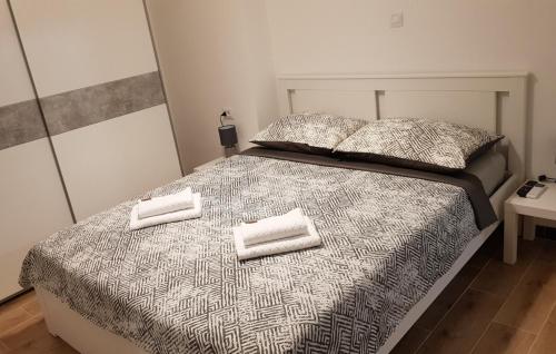 a bedroom with a bed with two towels on it at Apartment KaLea Pula Center By Villas Guide in Pula