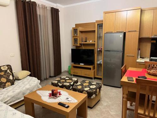 a living room with a refrigerator and a table at Golem, Mali i Robit in Golem