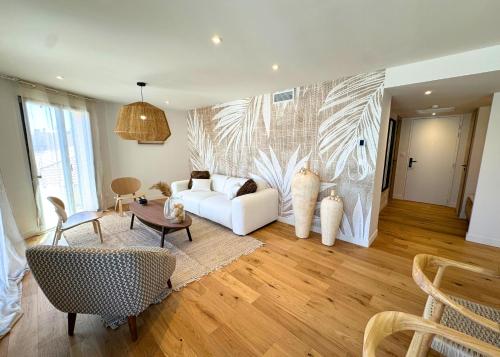 a living room with a white couch and a table at La Maison Cavet 5 Appartements de standing au cœur du village in Sanary-sur-Mer