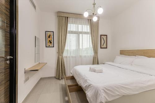 a bedroom with two beds and a window at Villa 371 - Al Ghadeer in Ghantoot