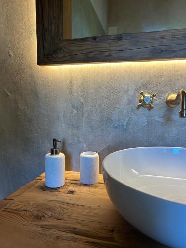 a bathroom with a sink and two towels on a counter at Il Glicine - Natural BnB in Castello di Godego