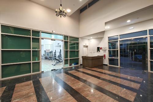 an empty lobby with a desk and glass doors at Villa 371 - Al Ghadeer in Ghantoot