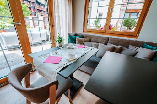 a dining room with a table and chairs at Hotel Eden Wellness in Zermatt