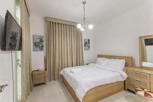 a small bedroom with a bed and a mirror at Villa 371 - Al Ghadeer in Ghantoot