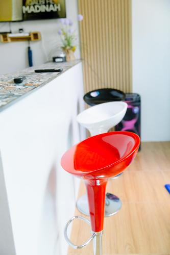 a red stool sitting next to a kitchen counter at Natacha Pool Villa 2 in Hat Yai Intl
