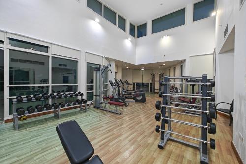 a gym with several treadmills and weights at Villa 371 - Al Ghadeer in Ghantoot