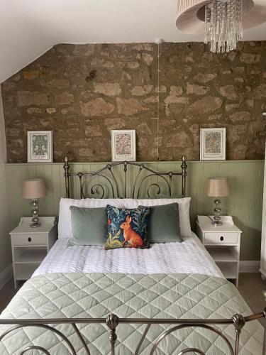 a bedroom with a large bed with two night stands at Riverside Cottage in Aycliffe