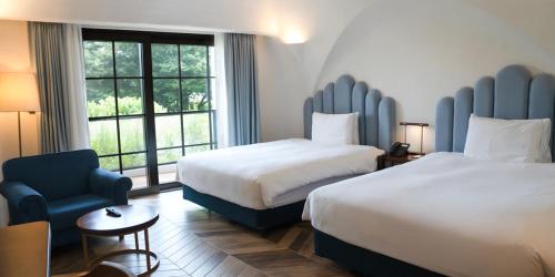Ein Bett oder Betten in einem Zimmer der Unterkunft Ecoland Hotel