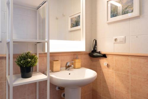 a bathroom with a sink and a mirror at Villa Mirto Golf in Chiclana de la Frontera