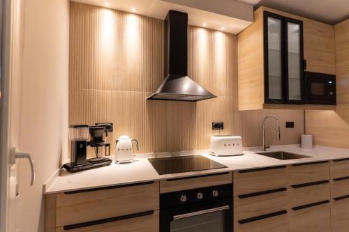 a kitchen with a sink and a stove at Braceli Beach Resort Middle Floor - rentafive in Santa Pola