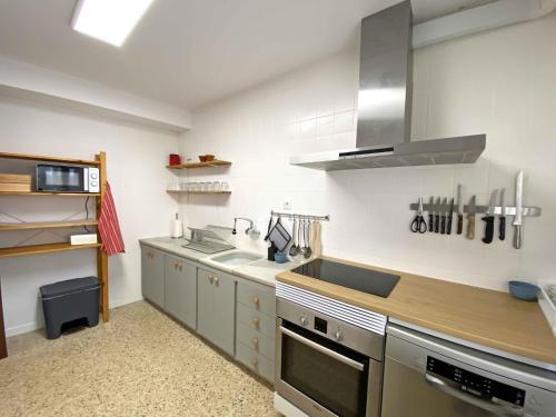 una cocina con fregadero y estufa en Casa Soñiga, en Tolva