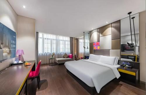 Ένα ή περισσότερα κρεβάτια σε δωμάτιο στο Urbain S Hotel SM Plaza Xiamen Gaoqi Airport Branch
