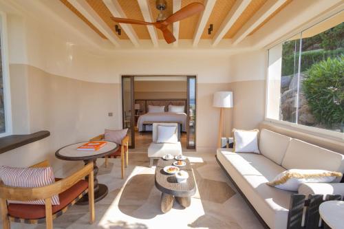 a living room with a couch and a bed at Hotel Pitrizza, Costa Smeralda in Porto Cervo