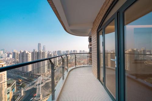 a balcony in a building with a view of a city at Pure home-Shanghai core high-floor house, large area, near Yuyuan Garden, the Bund People's Square,Commanding Panoramic Night of the Pearl Tower,Enjoying the stunning views of the Bund in Shanghai