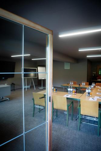 a room with a table and chairs and a glass door at Hotel Elisabeth, 4 Sterne Superior in Kirchberg in Tirol