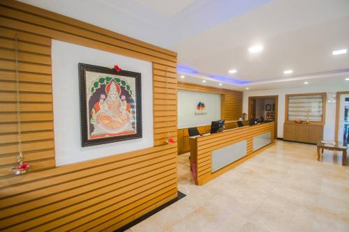 a lobby with a painting on the wall at Dwaraka inn -Premium Pool villa and event venue in Coimbatore