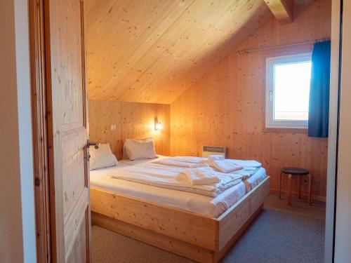 a bedroom with a large bed in a attic at Woody Park Feriendorf Murau in Murau