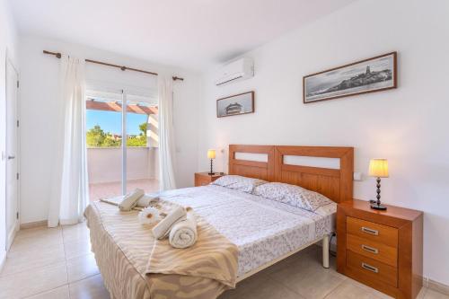 a bedroom with a bed with towels on it at Son Ganxo I in Cala Murada