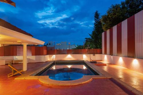 a swimming pool on the roof of a house at Dwaraka inn -Premium Pool villa and event venue in Coimbatore