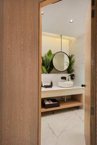 a bathroom with a sink and a mirror at AVA Hotel Chandigarh Zirakpur in Zirakpur