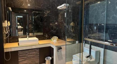a bathroom with a shower and a sink and a toilet at The BCC Hotel & Residence in Nagoya