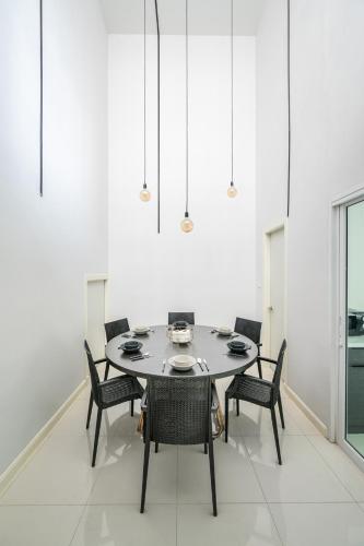 a dining room with a table and chairs at MIQ Asoke808 Villa - Asoke BTS - garden pool - 16 Pax in Bangkok