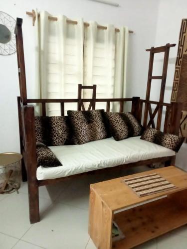 a couch with black and white pillows on it at Mavericks Convenient 2 BR in Diani's CBD in Kwale