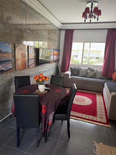 a living room with a table and a couch at Appartement F2, Perla saidia - plage a 5 min à pieds - Piscine en travaux in Saidia 