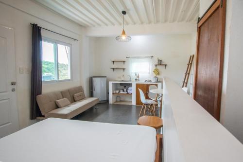 a kitchen and living room with a white counter top at Babosam Transient Dinihill in Boracay