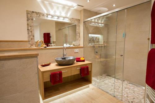 a bathroom with a sink and a shower at Wellness-Hotel ADLER in Bad Wörishofen