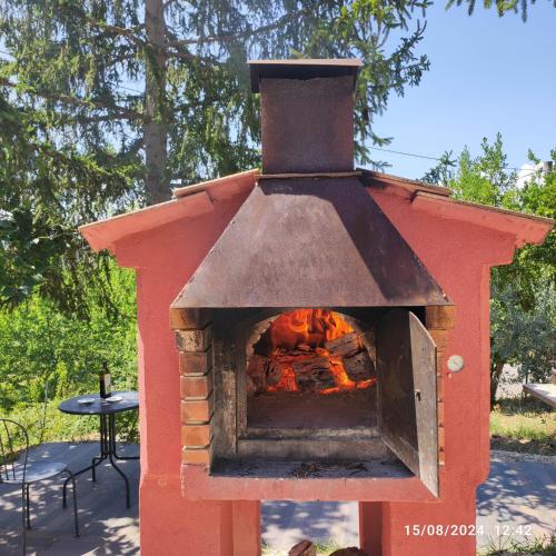 a red brick oven with a fire in it at Saecula Natural Village Experience in Force