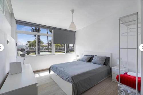 Un dormitorio con una cama y una ventana grande. en costa silencio, en Arona