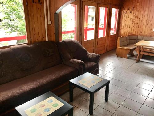 a living room with a couch and two tables at Cabana Dara in Cumpăna