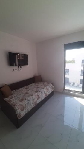 a bedroom with a bed and a flat screen tv at Apartment Cica in Igalo