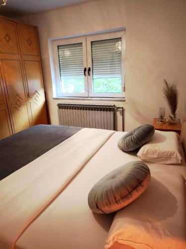 a bedroom with two large beds with pillows on them at Na brigu in Livno