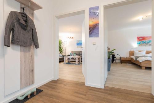 a hallway with a jacket hanging on a wall at Exkl App Tilda WLAN, Haustiere Willkommen in Börgerende-Rethwisch