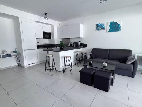 un salon avec un canapé et une cuisine dans l'établissement T2 à proximité des plages, à Saint-Cyr-sur-Mer